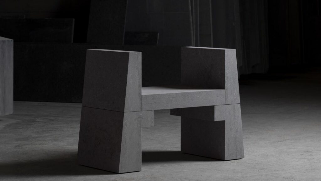 A geometric, H-shaped stone chair.