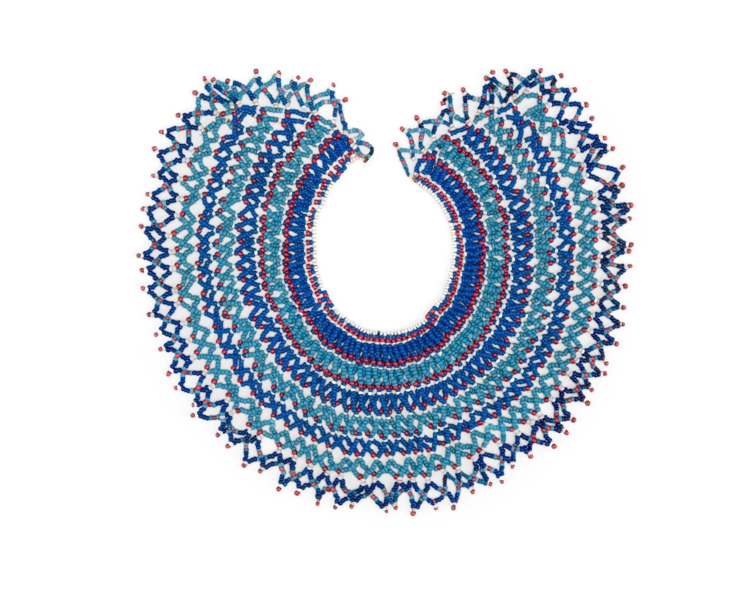 Beaded necklace with intricate, layered blue, turquoise, and red patterns, arranged in a circular, collar-like shape on a white background